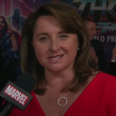 Victoria Alonso is wearing a red dress in the picture.